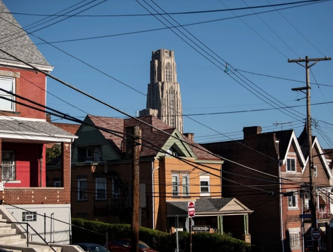 pcture of houses in Oakland with Cathedral of Learning in the background